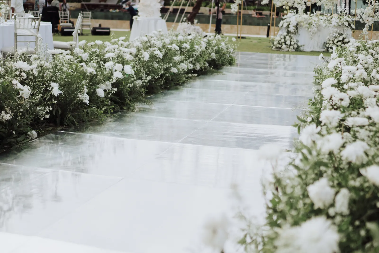 Mirror dance floor with white florals massed along both edges