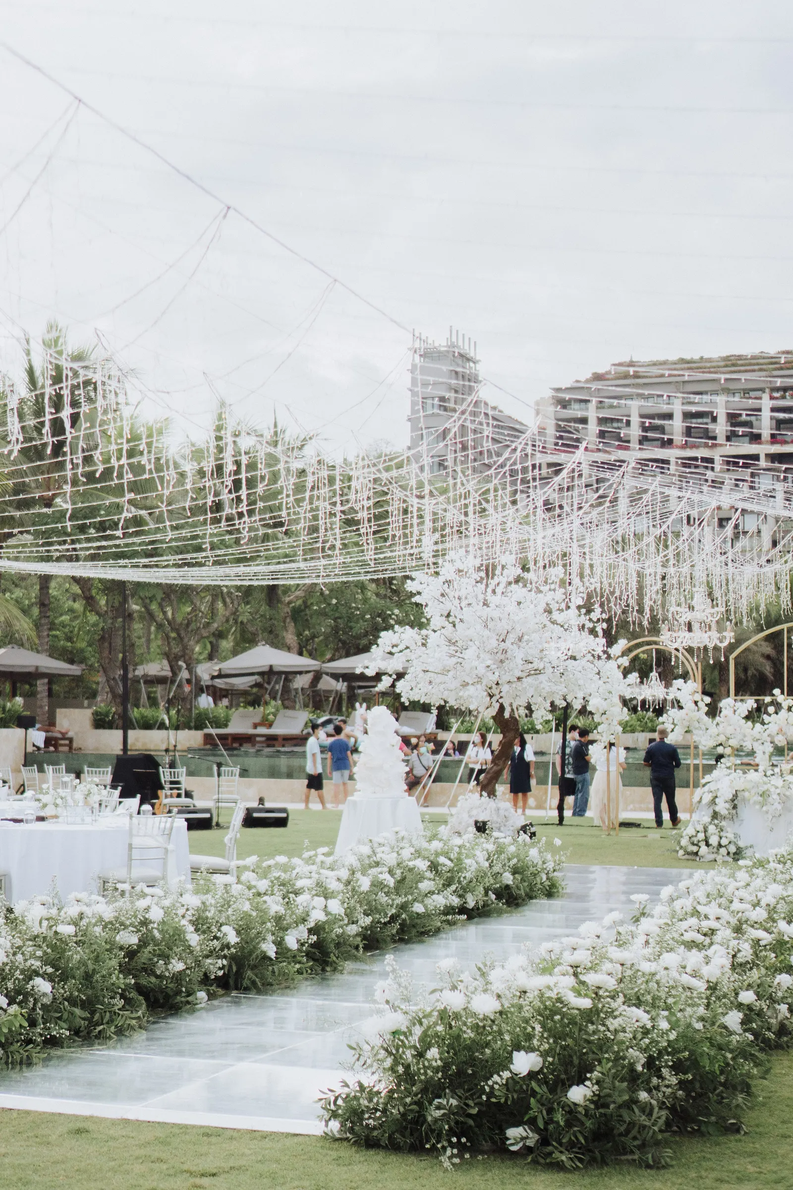 Wide view of the reception, mirror dance floor at the centre of the lawn