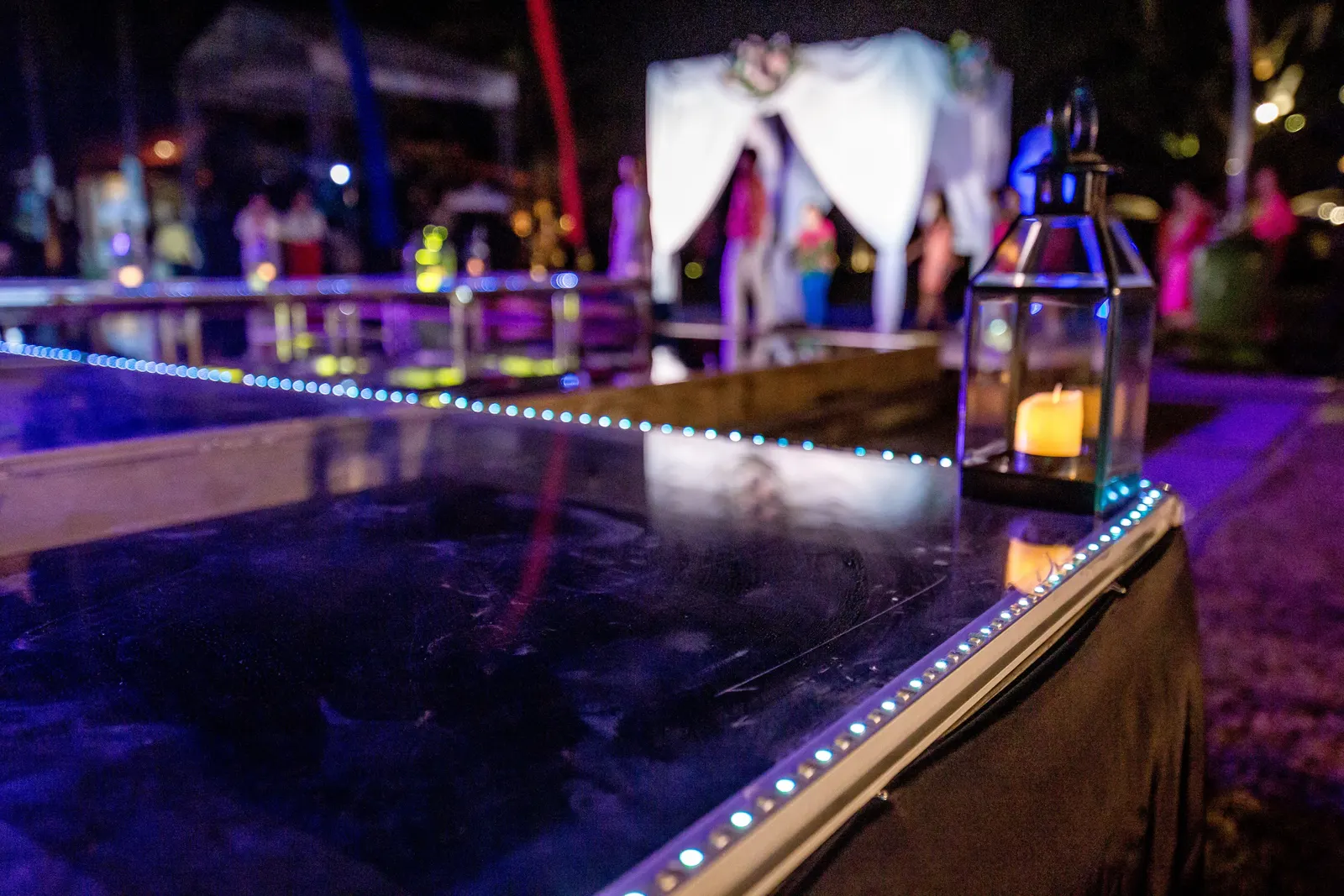 Edge of the acrylic floating stage at night, LED strip along the rim and lanterns on the surface